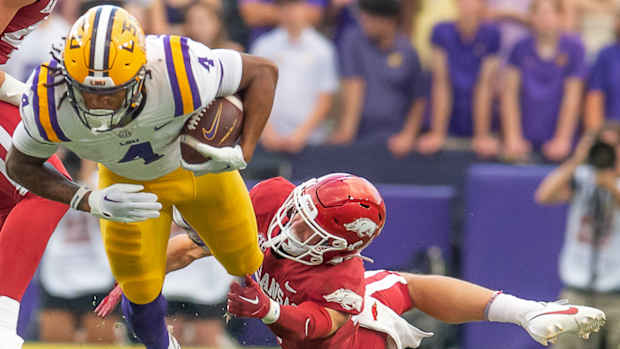 Razorbacks cornerback Hudson Clark tries to catch Brian Thomas Jr.